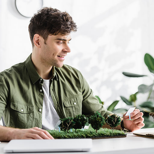 happy architect working with a model